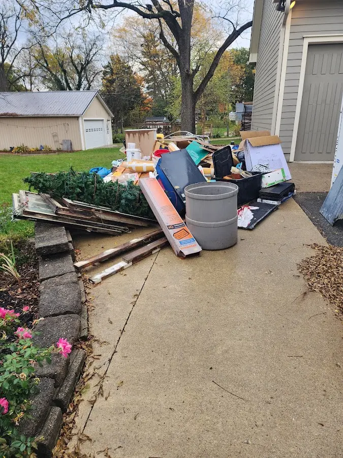 Dumpster being loaded with debris for 10 Yard Dumpster Rental in Upper St. Clair